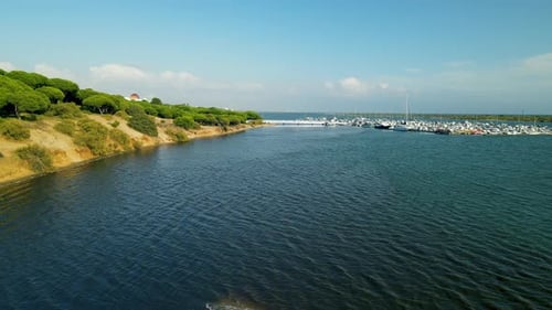 Puerto El Rompido Sailboat and yacht club with many vessels moored in dock on Piedras river, aerial