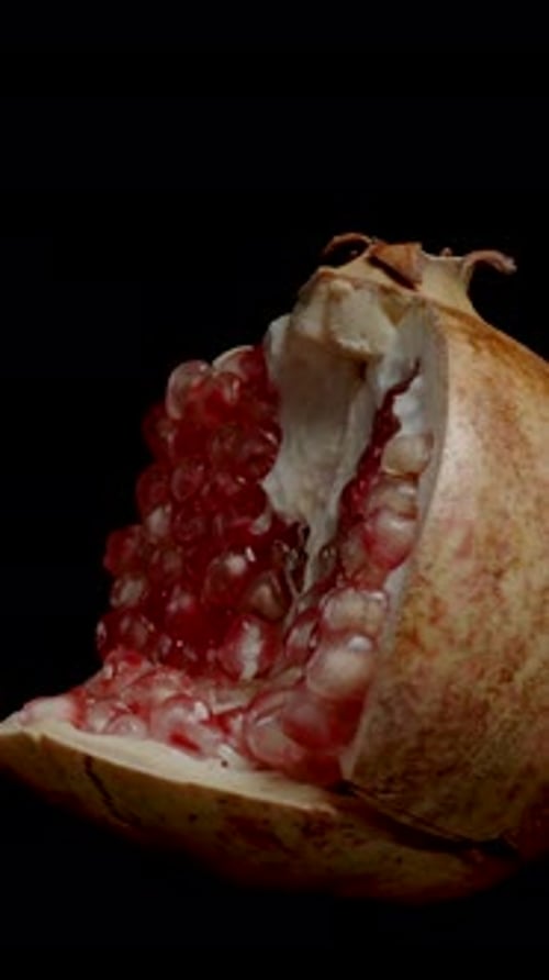 Vertical video. Variety of Pomegranate with White Transparent Seeds, isolated, looped video.
