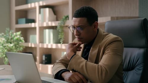 Thoughtful Ethnic Man African American Businessman Employer Working Online with Laptop in Office