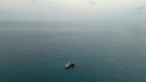 A drone captures footage of a fishing trawler, surrounded by seagulls, as it hauls in a bountiful ne