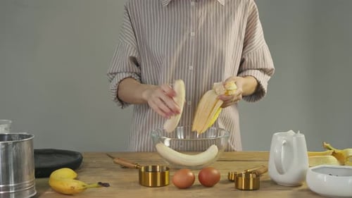 Before Cooking a Banana Tart a Woman Peels the Banana