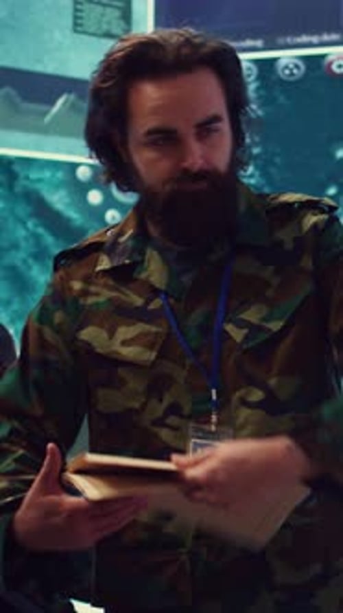 Man in Camouflage Uniform Reviews Data in Office
