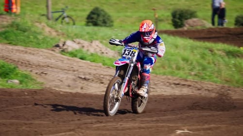 Extreme Motocross MX Competition in Berlin - Rider Riding on a Dirt Track - Tracking shot