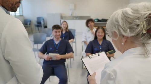 Medical Students Raising Hands During Hospital Lecture in Slow Motion