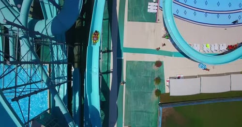 Aerial view of people sliding down a water slide at a water park
