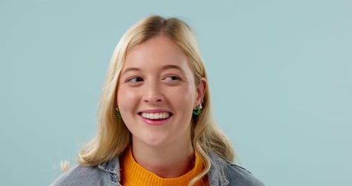 Woman, secret and hand on lips in studio for gossip, surprise or announcement on blue background