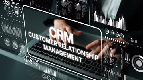 Person Typing on Laptop with Customer Relationship Management Overlay