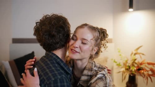 Loving Couple Embrace and Kiss in Bedroom Setting