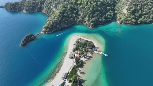 Vertical drone shot showing the bright seasonal colors of Ölüdeniz’s iconic lagoon.