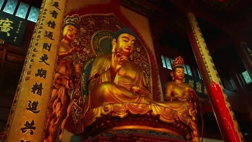 Large Golden Buddha Statue Seated in Temple Interior