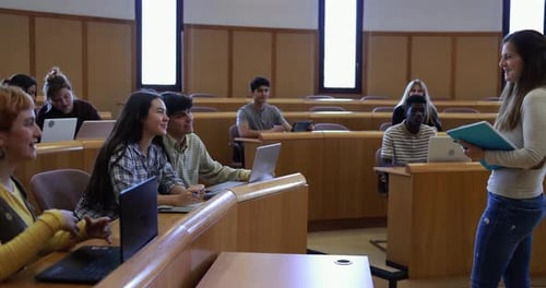 Engaging teacher guiding diverse students in classroom at university