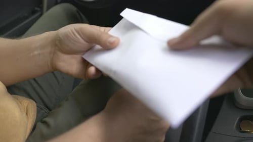 The Man Takes a Bribe From a Civil Servant and Counts the Money in the Car