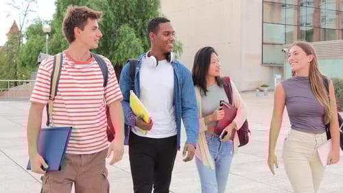 Four Teenage Real Students Walking Smiling and Talking Together at University Campus Group of Young