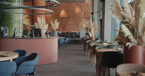 A Vibrant Restaurant with Tables Lush Plants and a Cozy Vibe