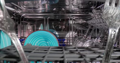 Clean Dishware in Shiny Modern Dishwasher