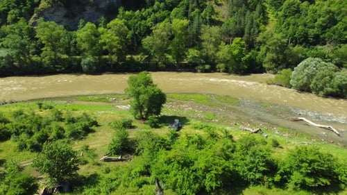 Fluss fließt durch ein grünes Tal mit Bergen