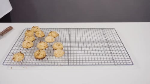 Baker Cooling Coconut Macaroons on Rack