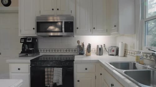 Gimbal shot of and empty white kitchen in the suburbs