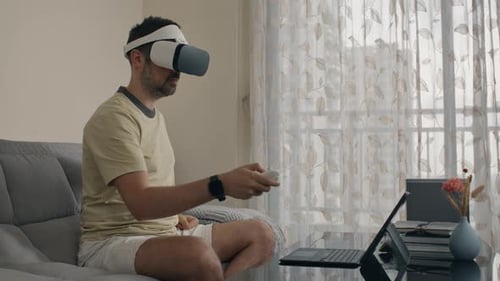 Man Using Virtual Reality Headset in Living Room