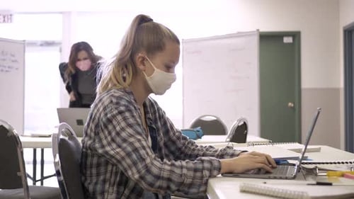 High School Girl Student in Face Mask Studying at Laptop in Classroom Caucasian