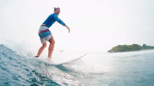Surfing in Maldives. Man surfs the ocean wave in tropics