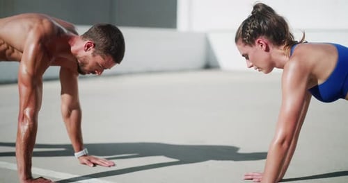 Young Adults Doing Pushups Outdoors