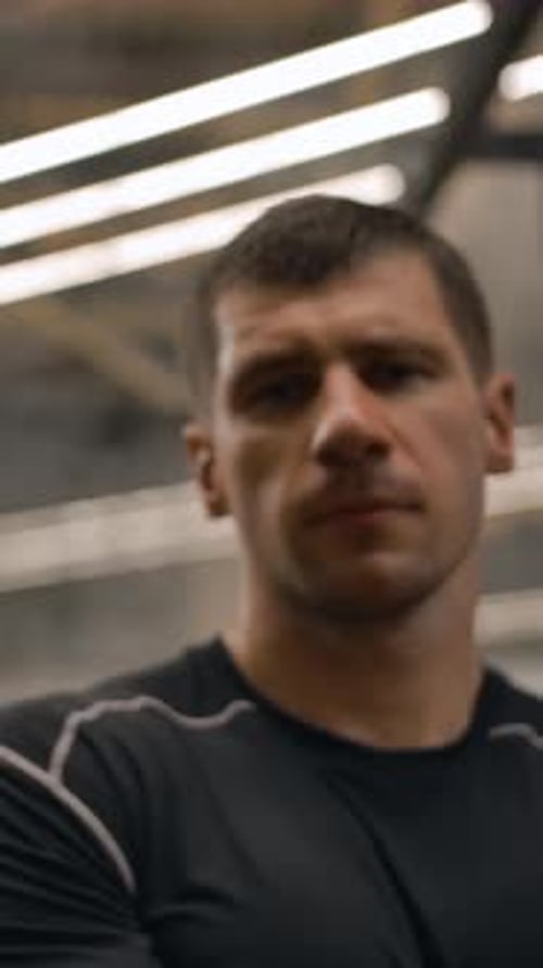 Vertical of Dolly Shot on the Face of Professional Athlete in the Gym