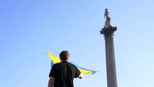 Man Holding Flag in Urban Setting