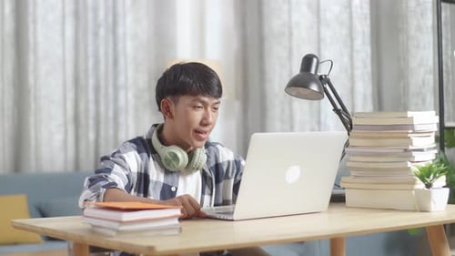 Teen Boy Talking on Laptop at Desk