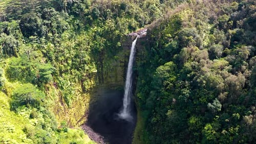 Aerial View of Towering Rainforest Waterfall into Volcanic Basin