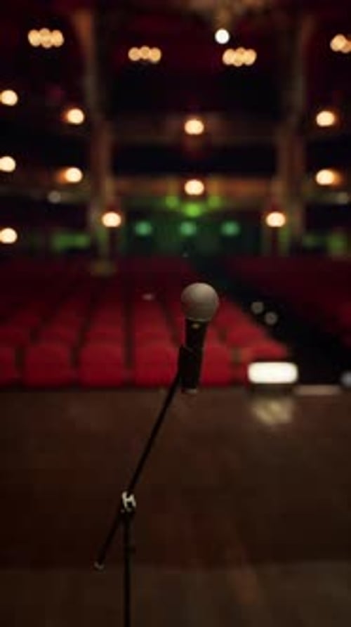 Microphone on Stage with Empty Theater Background