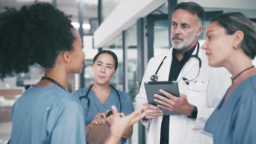 Man, doctor and tablet in meeting with team of interns, nurses or medical employees at hospital