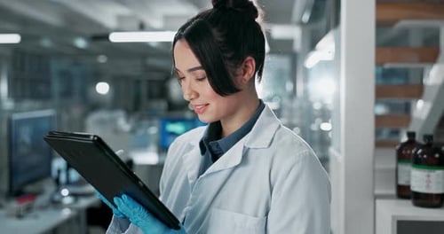 Scientist Working on Tablet in Modern Laboratory