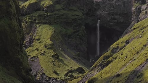 Aerial View of Waterfall Cascading Into Rocky Gorge in Iceland