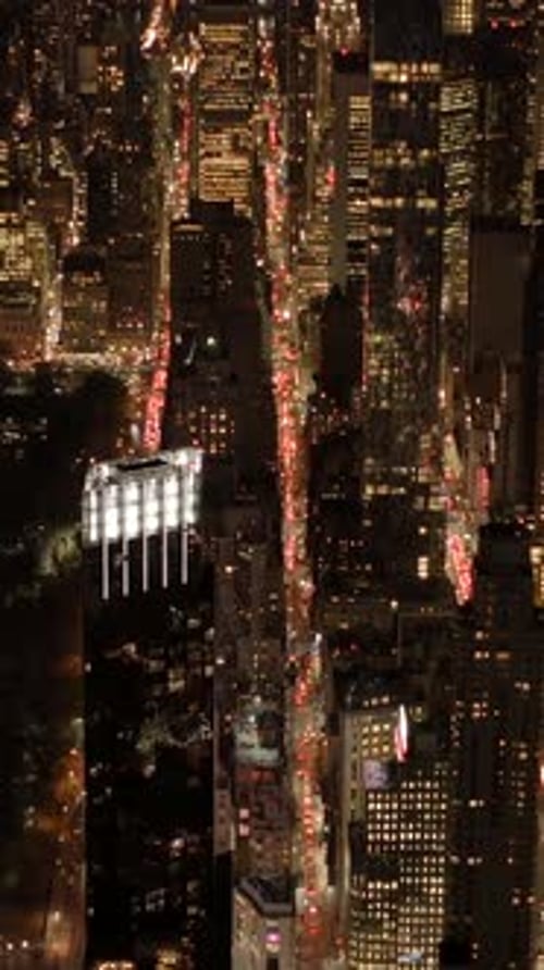 Experience the Stunning Night View of a Bustling Cityscape Filled with Life and Lights