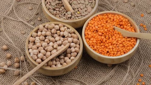 Raw Lentils and Chickpeas in Rustic Wooden Bowls