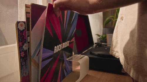 Vinyl records and record player on table indoors