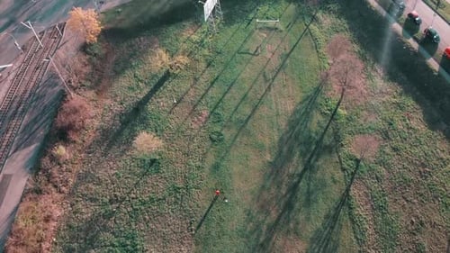 Flying over football field in the middle of a deserted technolohy park in Germany, Europe with view