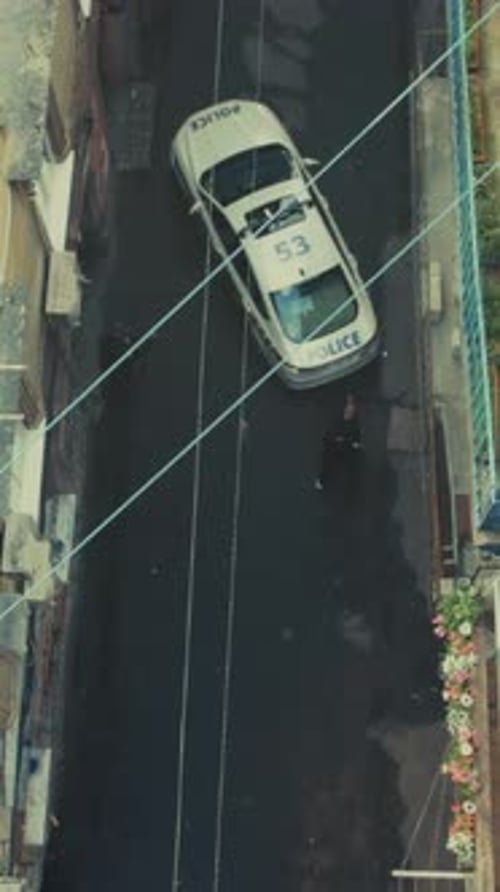 Officers Exit Narrow Urban Alleyway Peacefully City Police Vehicle Departs Alley As Officers Walk