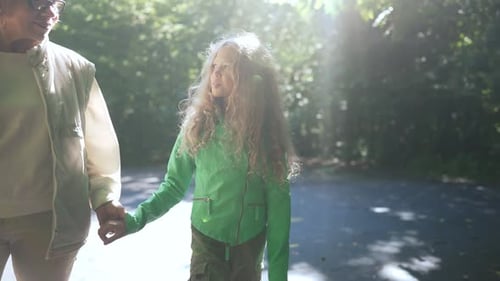 Grandmother and Child Walking Together in the Park
