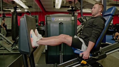 Man Doing Leg Presses at the Gym
