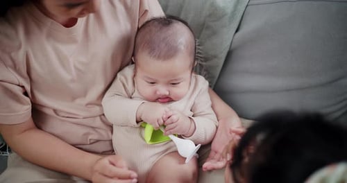 Loving Infant playing with Family Inside Home