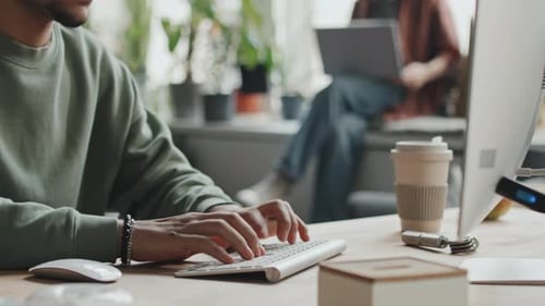 Developer Typing on Computer at his Workplace
