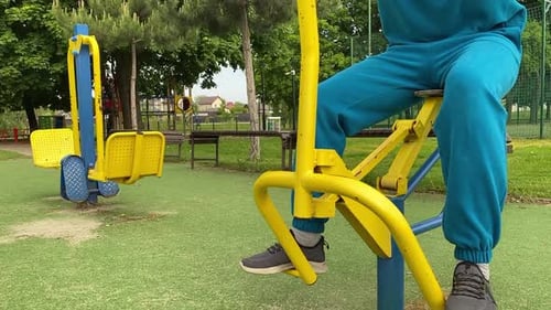 A male athlete works out at the outdoor gym