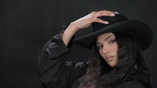 Stylish Woman Posing with a Black Hat