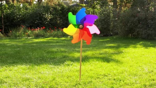 Ecology, Environment And Sustainable Energy Concept - Colorful Pinwheel Rotating Outdoors In Summer