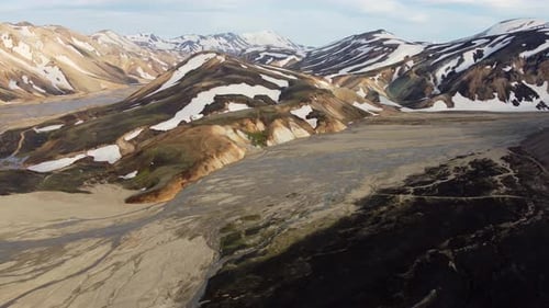 The aerial panorama of two valleys with glacier rivers in the rainbow mountains of Landmannalaugar i