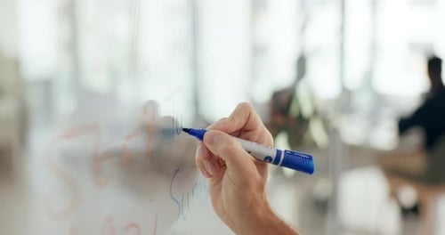 Hand, writing and glass wall for business strategy with brainstorming in office solution
