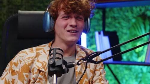 Young Blogger Recording Podcast in Studio with Neon Light