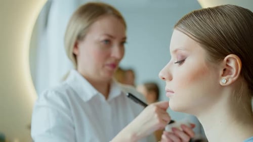 Makeup Artist Work in Her Beauty Studio Portrait of Woman Applying By Professional Make Up Master